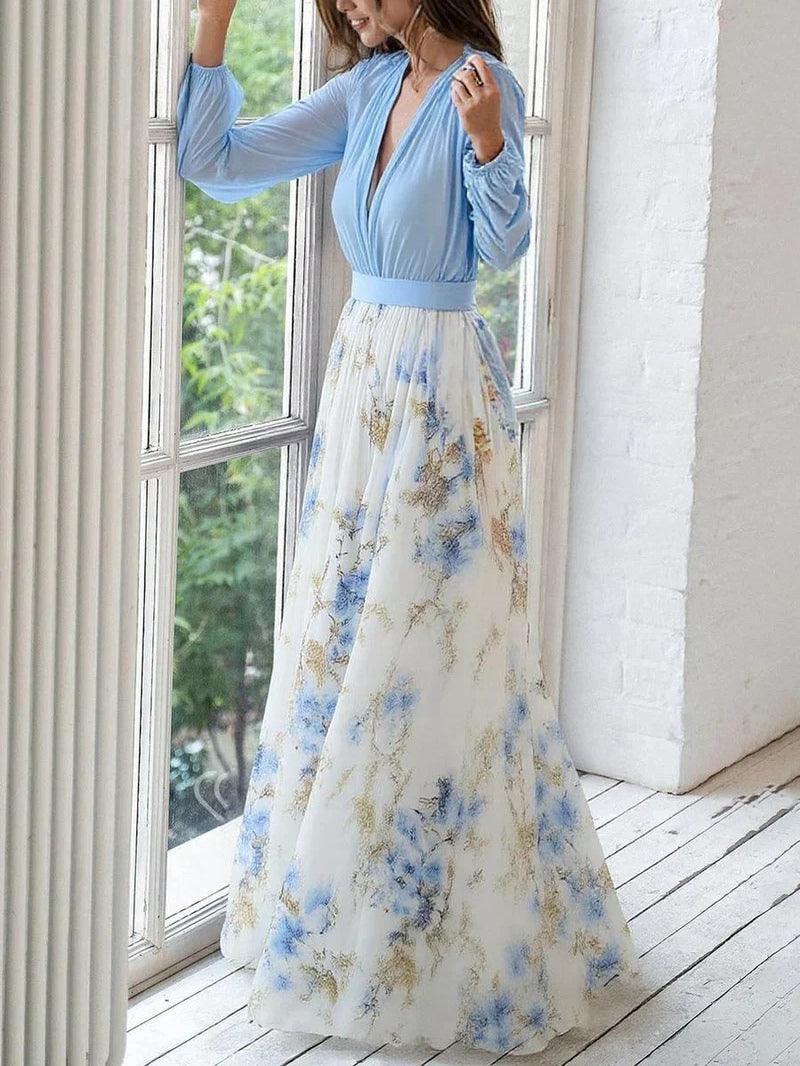 Light blue V-neck maxi dress with long sleeves, fitted waist, and floral print skirt