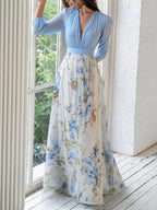 Light blue V-neck maxi dress with long sleeves and flowing blue floral print skirt