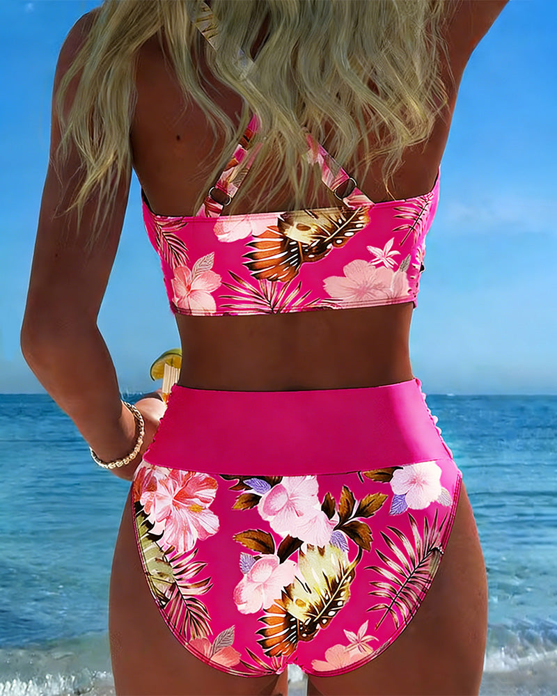 Floral contrast split bikini with bright pink halter top and tropical floral high-waist bottoms