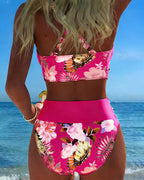 Floral contrast split bikini with bright pink halter top and tropical floral high-waist bottoms