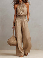 Beige linen-blend halter jumpsuit with smocked waist and wide-leg pants