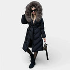 Long black puffer jacket with taupe fur hood, button front, and waist tie belt.