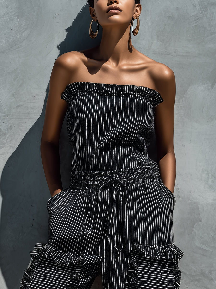 Black and white striped strapless jumpsuit with smocked bodice and ruffled tiers
