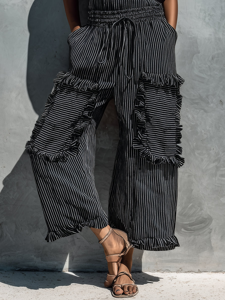 Black and white striped strapless jumpsuit with drawstring waist and cargo-style ruffle legs