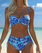 Blue abstract print bikini with thin straps, knot bandeau top, and tied side bottoms