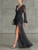 Dark grey ruched lace sheer maxi dress, long sleeves, side view with high slit