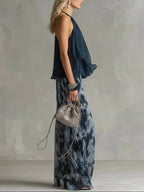 Navy chiffon halter-neck top with flowing ruffles and printed wide-leg pants set