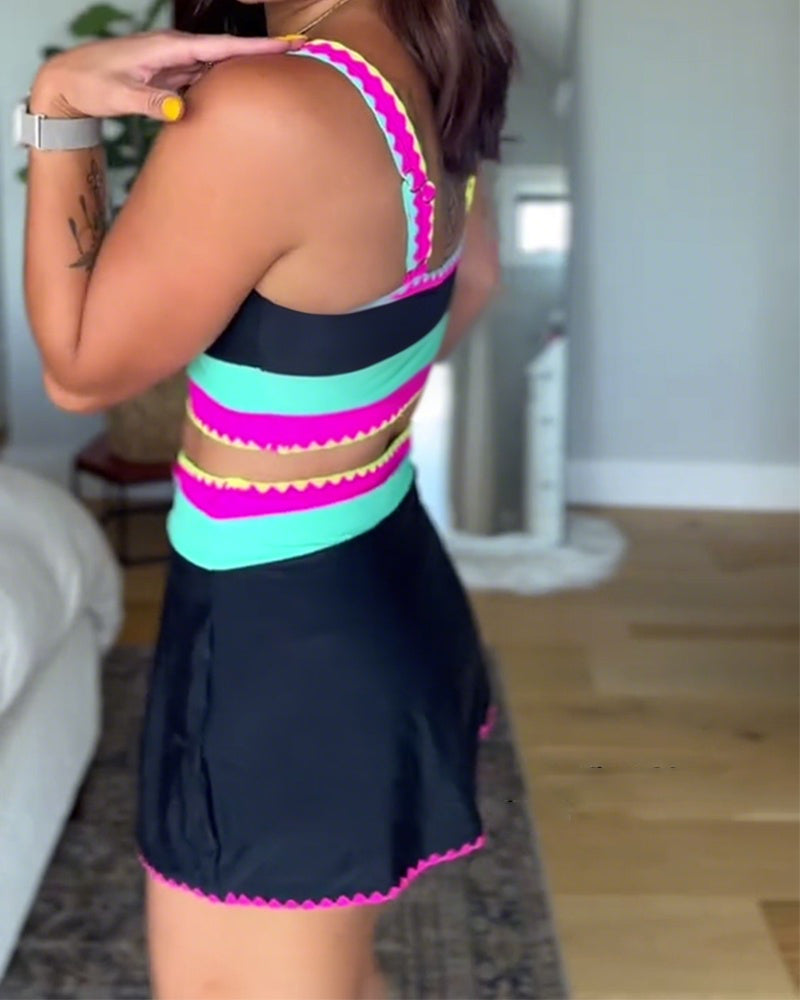 Color-block three-piece swimsuit, black with neon pink and teal bands, back view.