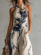 Beige halter neck jumpsuit with blue ink-wash print and tie halter neckline