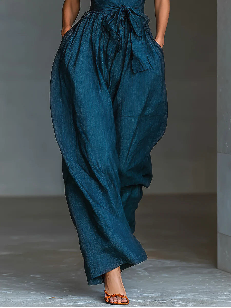 Chic halter jumpsuit in deep teal with gathered waist and wide leg