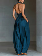 Blue halter wide-leg jumpsuit with open back and tied waist