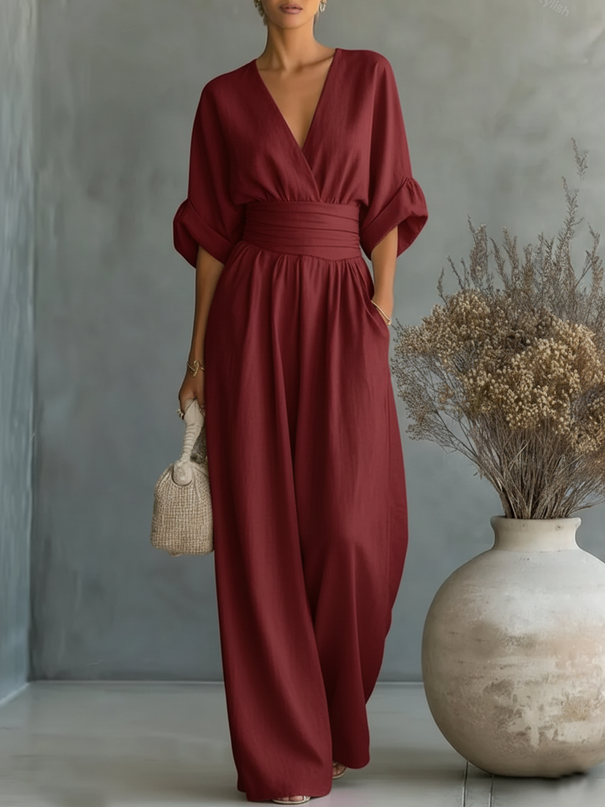 Burgundy V-neck high-waist jumpsuit with cinched waist and wide-leg flow, dolman sleeves