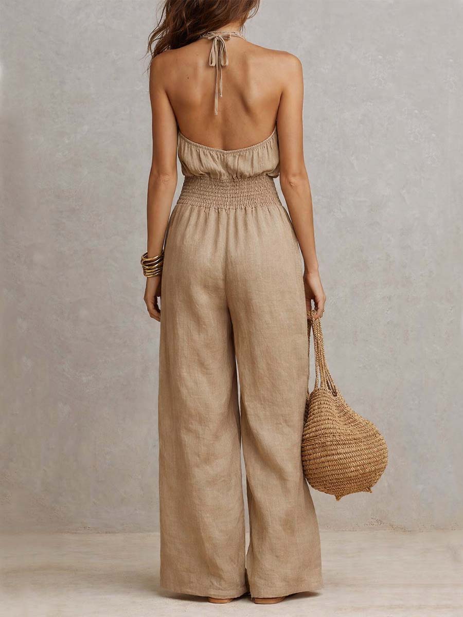 Beige halter backless jumpsuit with tie at neck, smocked waist, wide legs
