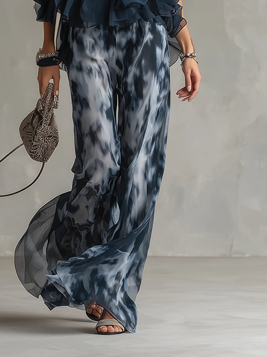 Printed wide-leg pants with flowing chiffon overlay and dark ruffled waistband