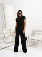 Black sleeveless top and wide-leg pants two-piece set with waist belt