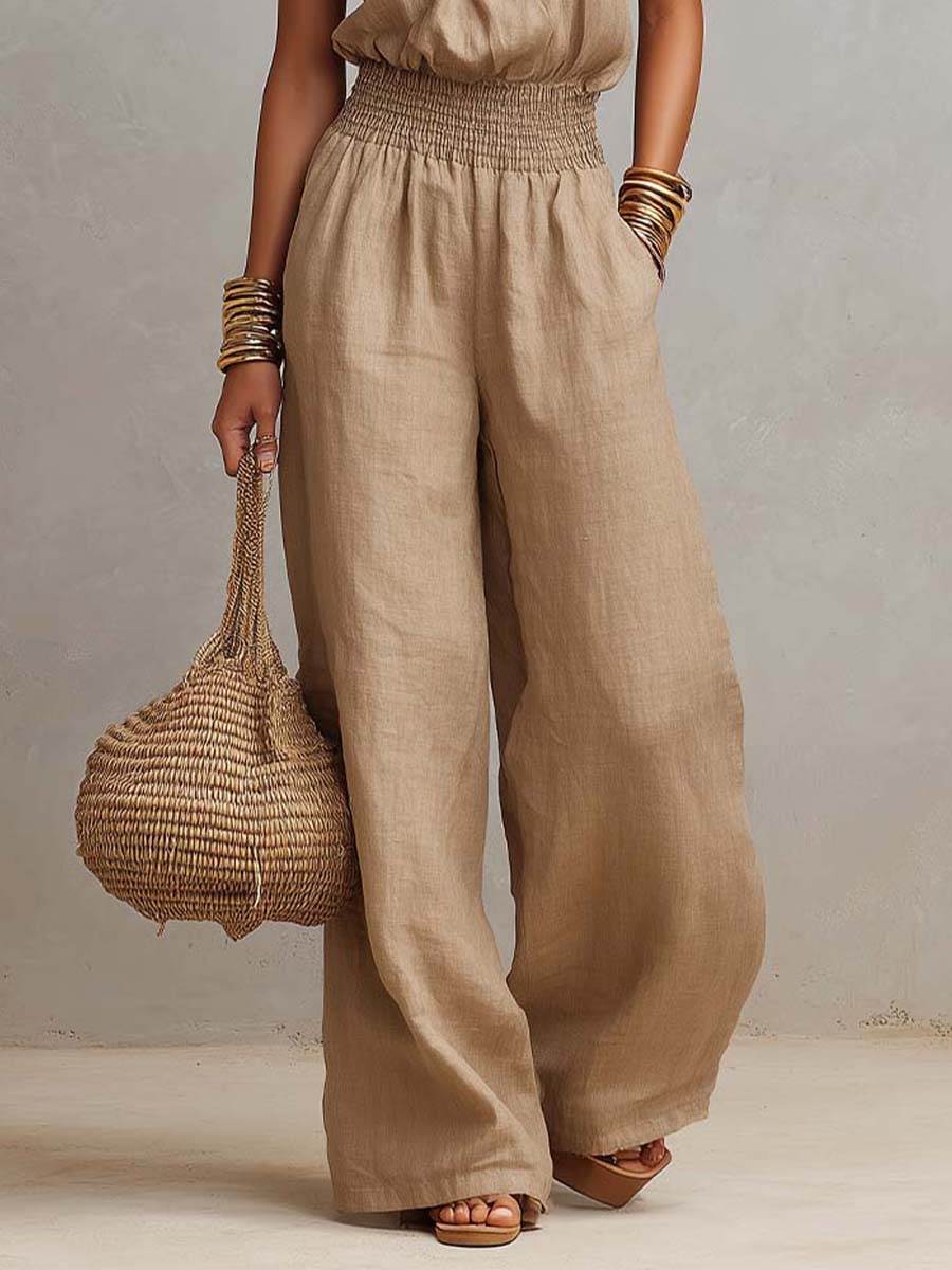 Beige smocked-waist wide-leg jumpsuit with side drape and linen texture