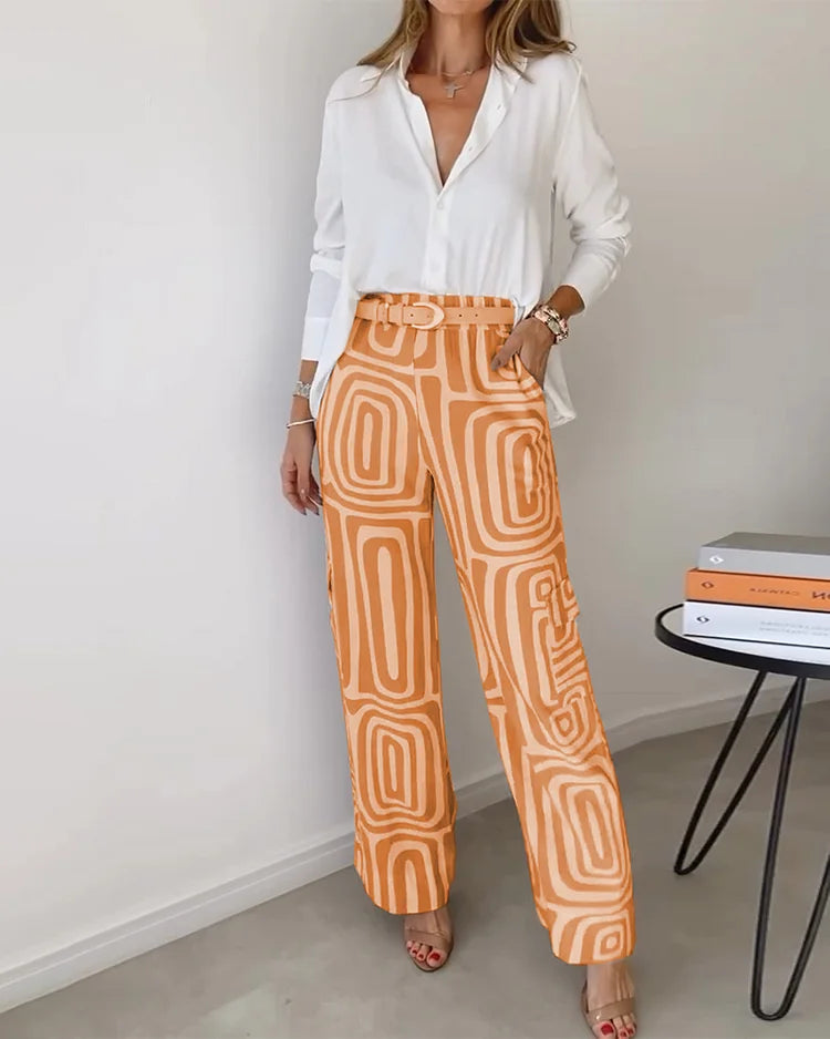 Two-piece set: white button-front blouse with orange patterned wide-leg pants