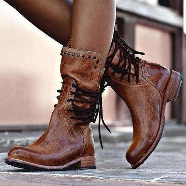 Brown vintage lace-up boots with studded side straps and black laces