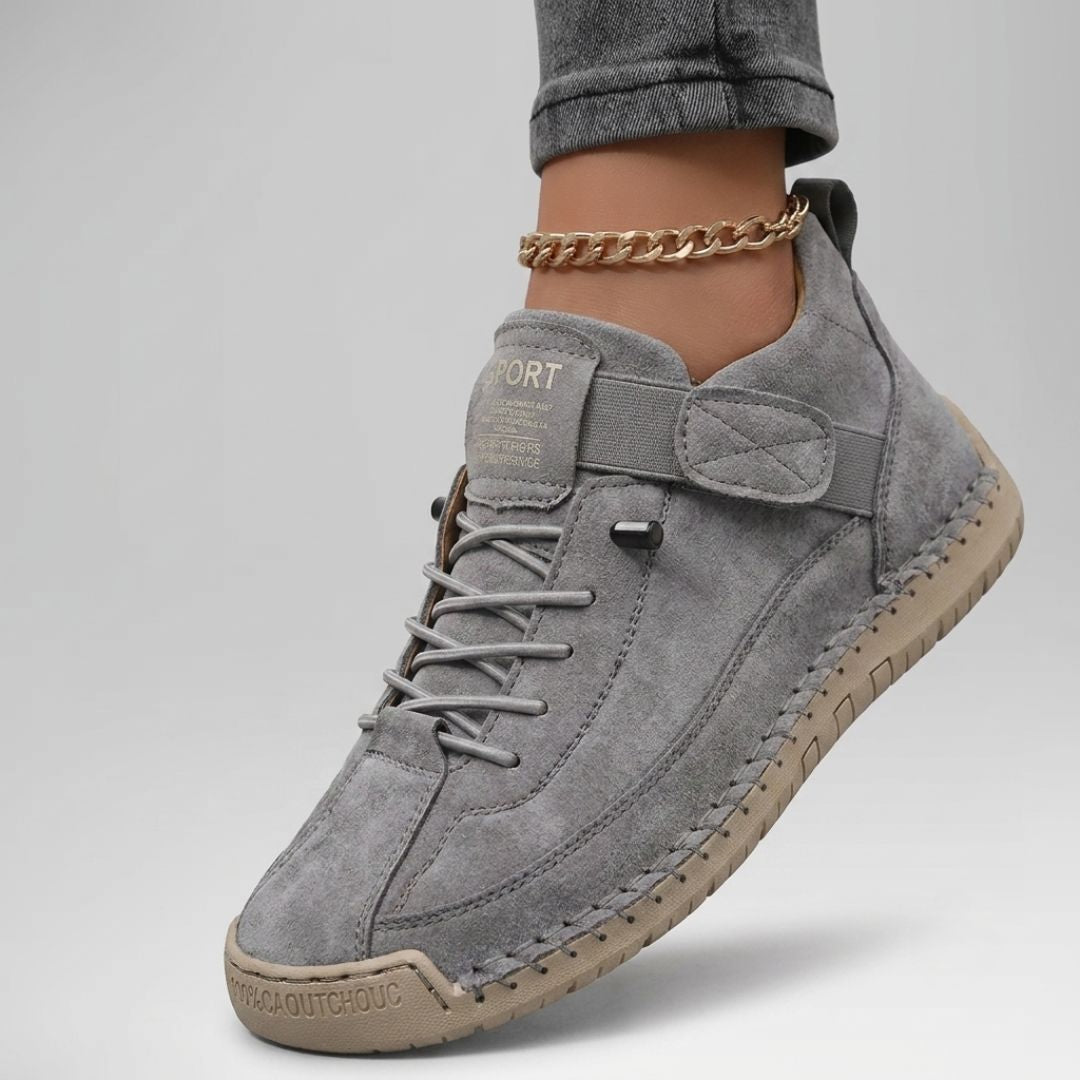 Gray comfort support sneaker with lace-up, ankle chain, and suede heel panel
