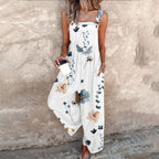 White sleeveless jumpsuit with blue floral and leafy print, wide-leg fit