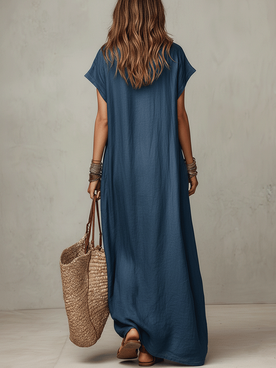 Blue relaxed maxi dress from back view with short sleeves and flowing hem