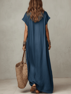Blue relaxed maxi dress from back view with short sleeves and flowing hem