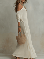 Soft ivory one-shoulder textured maxi dress with long sleeves and flowing hem