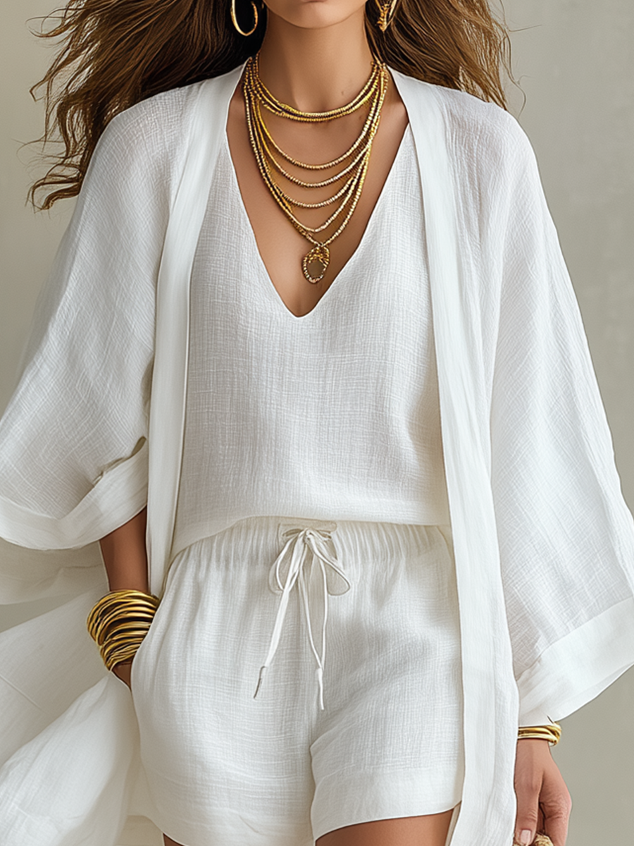 White sleeveless V-neck top with drawstring shorts and open kimono layer, front close-up