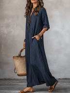 Blue loose-fit maxi dress with V-neck and vertical pinstripes, side view with draped skirt