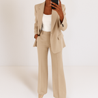 Beige tailored two-piece suit set with blazer and matching trousers, single-breasted.