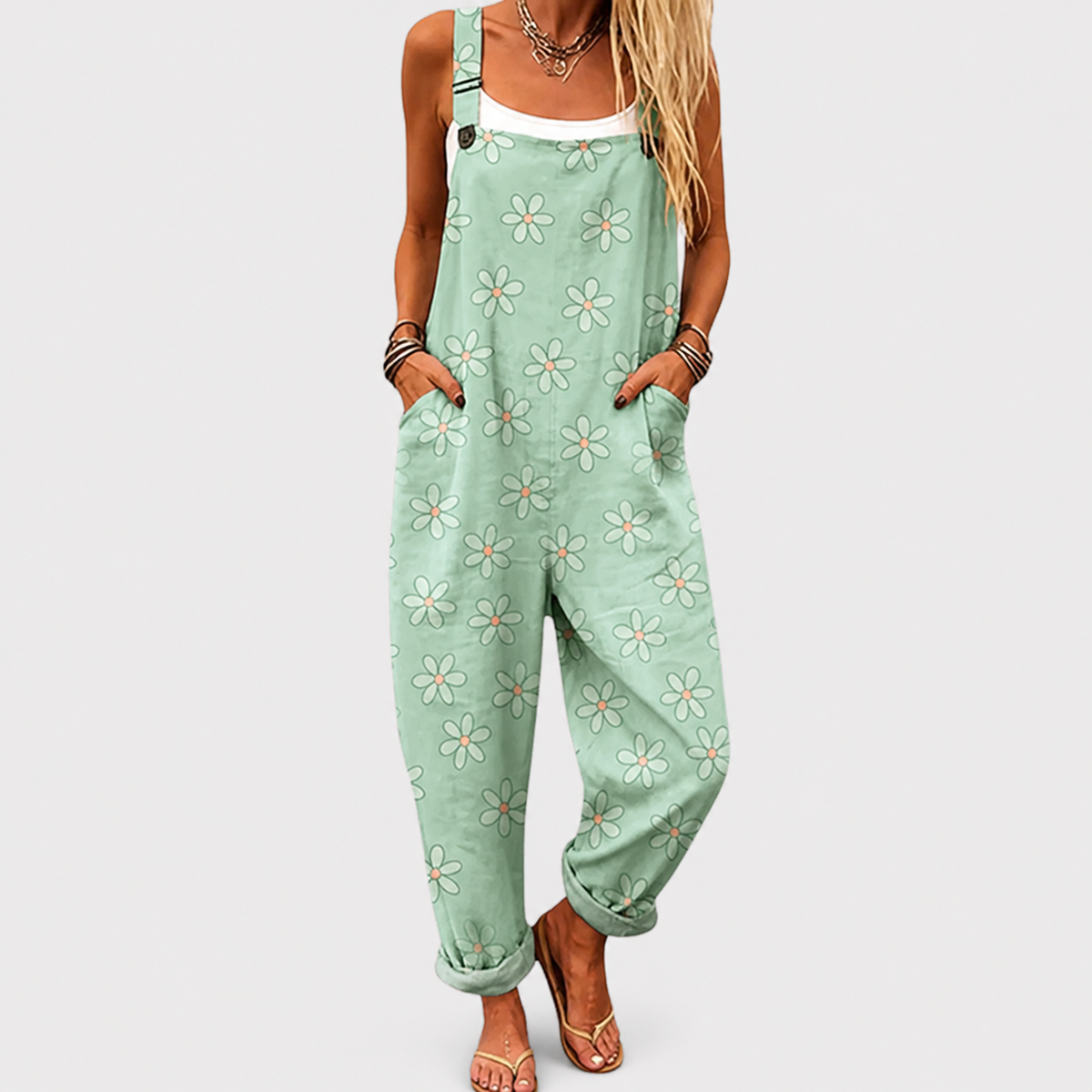 Mint green floral printed sleeveless jumpsuit with front pockets and tapered legs