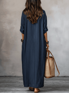 Blue indigo maxi dress back view with vertical stripes and loose, ankle-length cut