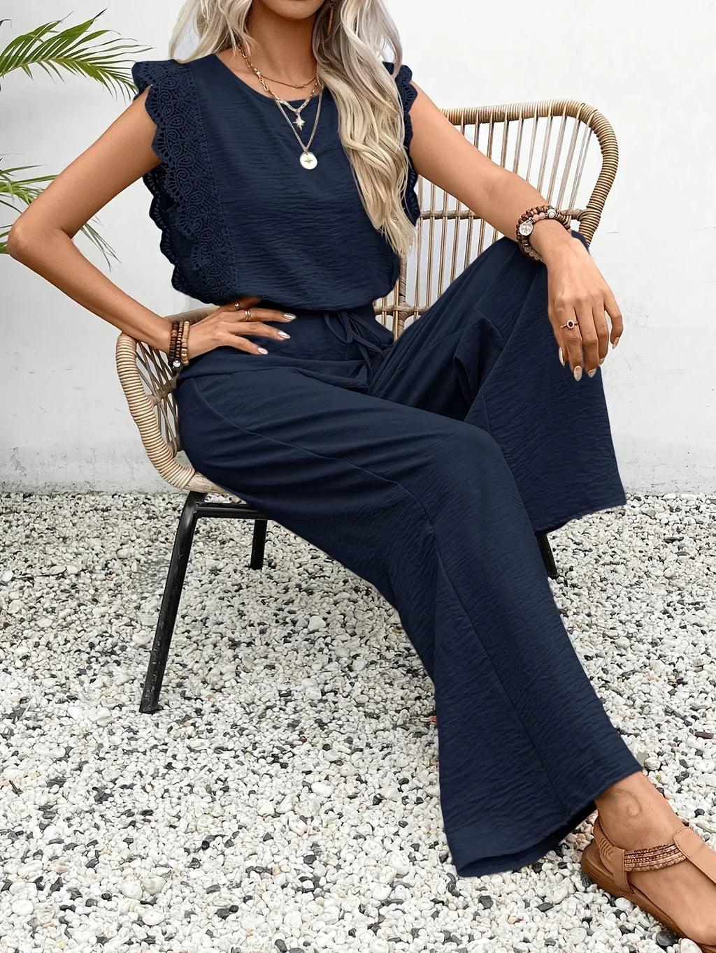 Navy blue wide-leg two-piece set with drawstring waist and ruffled shoulder top
