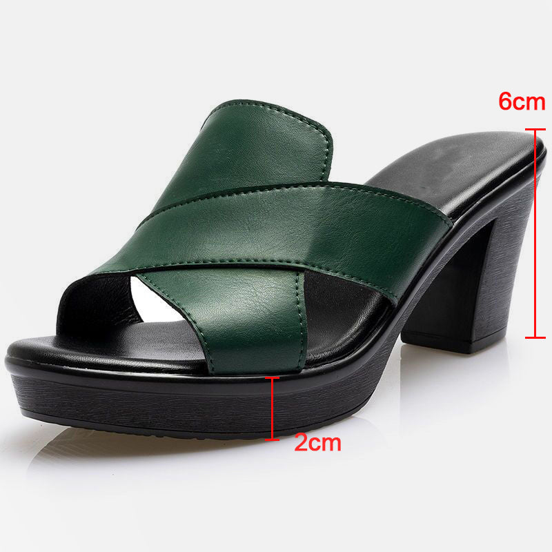 Green orthopedic sandals close-up; strap stitching visible and 2cm sole height.