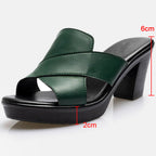 Green orthopedic sandals close-up; strap stitching visible and 2cm sole height.