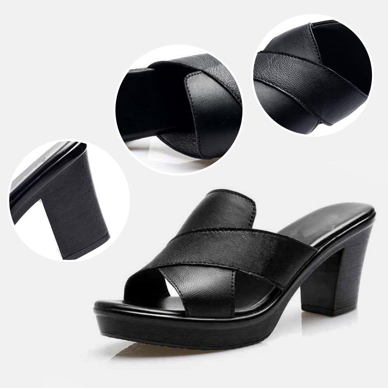 Black orthopedic sandals with crisscross straps, thick sole, and mid block heel.