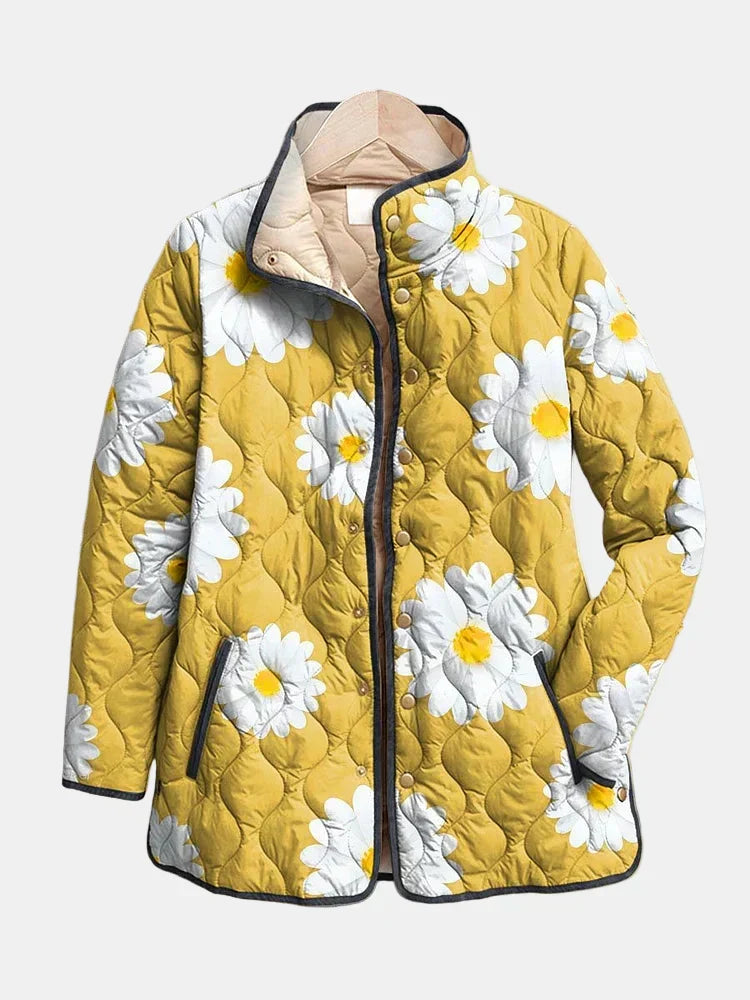 Yellow daisy-pattern quilted jacket with white flowers, zip-front and dark trim.