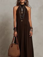 Dark brown halter neck long dress with loose sleeveless fit and flowy skirt