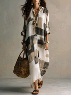Off-white maxi dress with abstract black-and-gray block print, button-front placket, 3/4 sleeves
