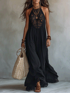 Black sleeveless maxi dress with lace halter yoke and flowing draped skirt