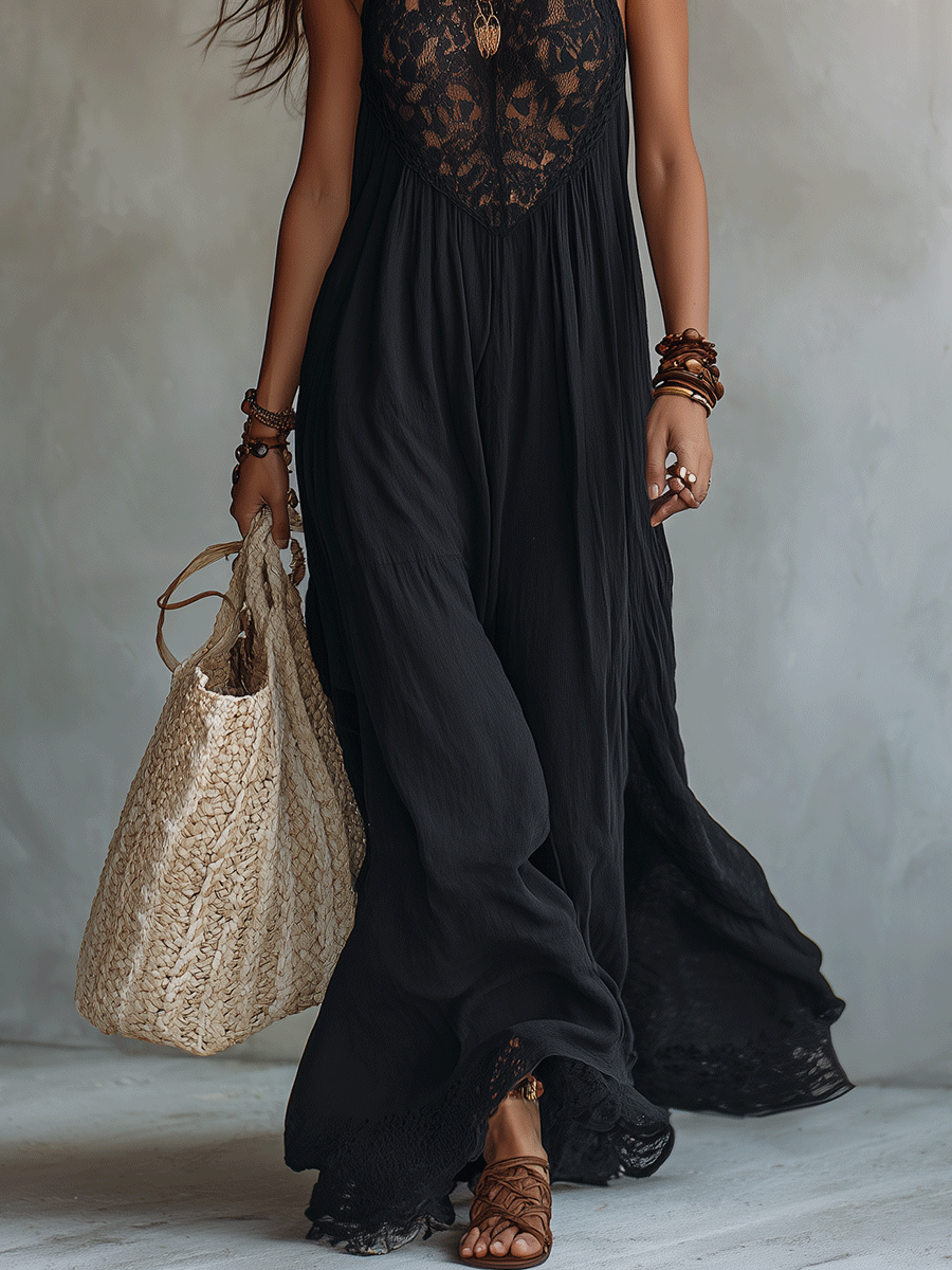 Black sleeveless maxi dress lower view with lace hem, flowing skirt, and tote bag