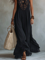 Black sleeveless maxi dress lower view with lace hem, flowing skirt, and tote bag