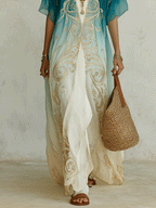 Lower-body view of aqua ombre kaftan maxi dress with gold embroidery and cream draped pants