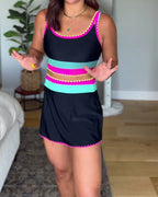 Color-block three-piece swimsuit, black with bright pink and teal stripes, front view.