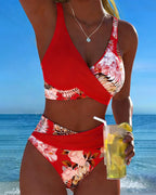 Floral contrast split bikini with red halter top and matching high-waist floral bottoms