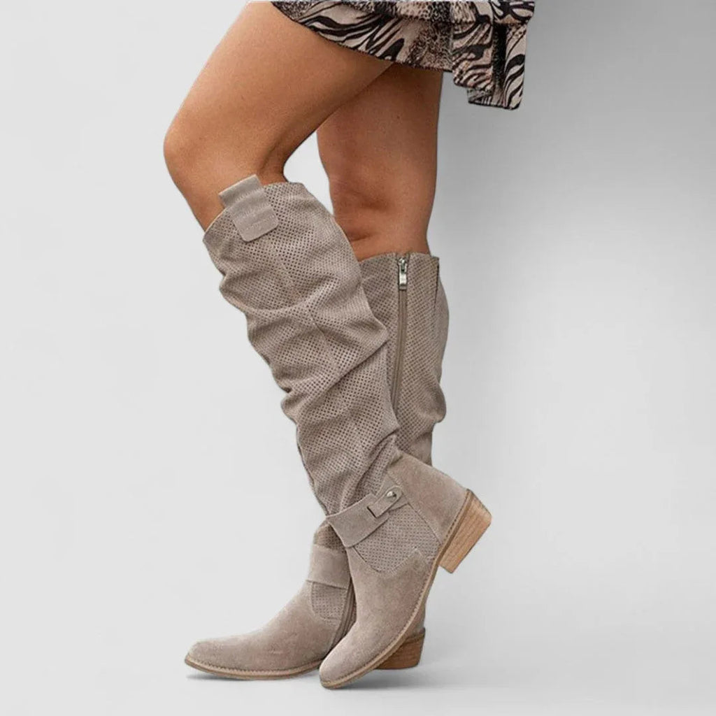 Beige orthopedic western boots, slouchy tall shaft with snap strap details and block heel.