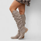 Beige orthopedic western boots, slouchy tall shaft with snap strap details and block heel.