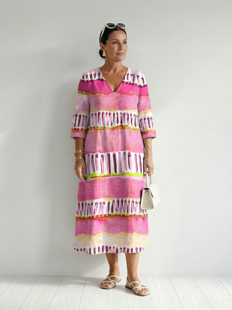 Pink striped tiered midi dress with tassel trim and 3/4 sleeves