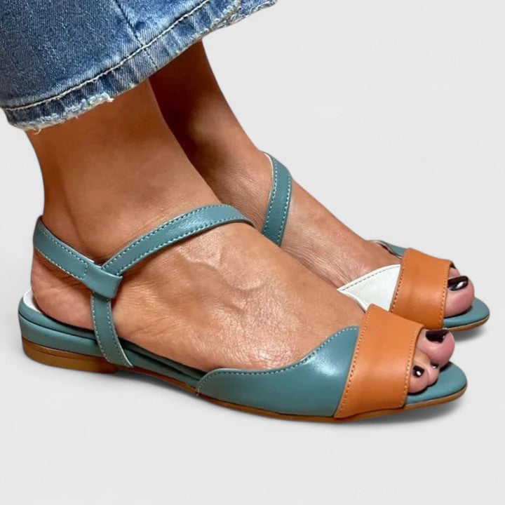 Color-block open-toe flat sandals with two straps and decorative toe face, teal and tan