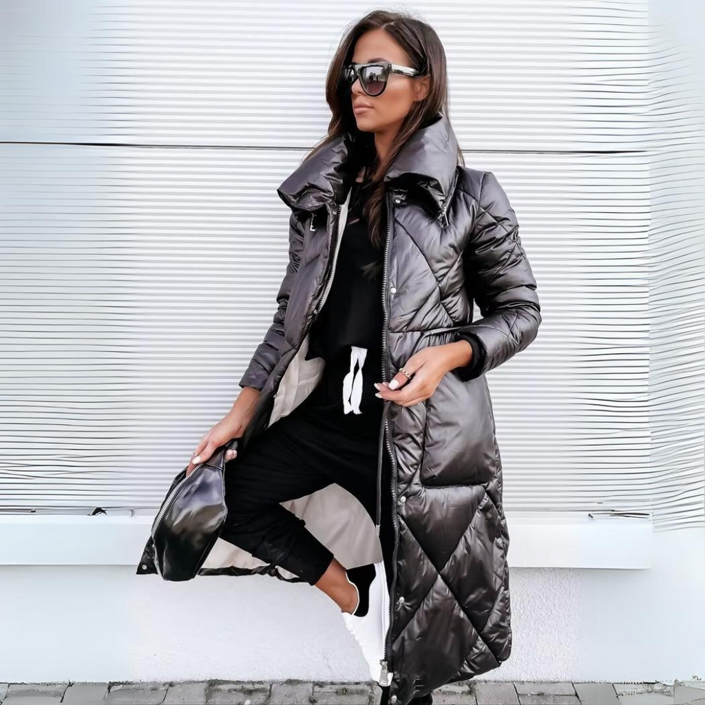 Black quilted long puffer winter coat with hood, front zipper, side pockets.